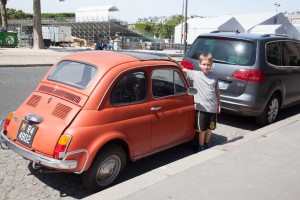 Tom finds a car his size near the Eiffel Tower.