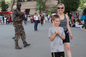 Tom walks over to armed soldiers to say hi, then walks away nervously.