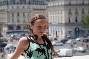 Madeleine taking in the view from the Grand Balcon overlooking Place de l'Opéra.